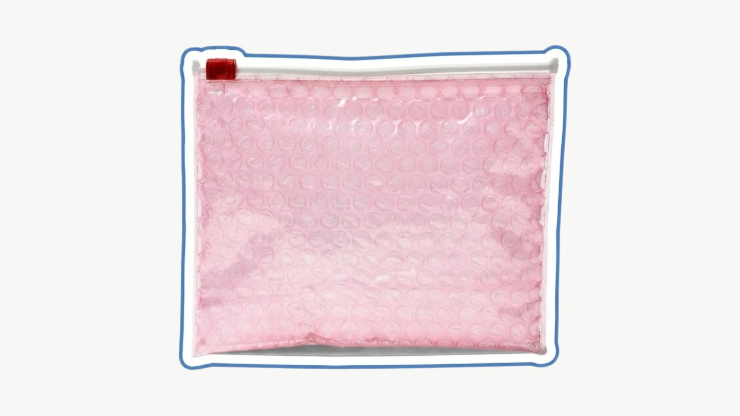 The Glossier pouch, a pink bubble-wrap zip bag.